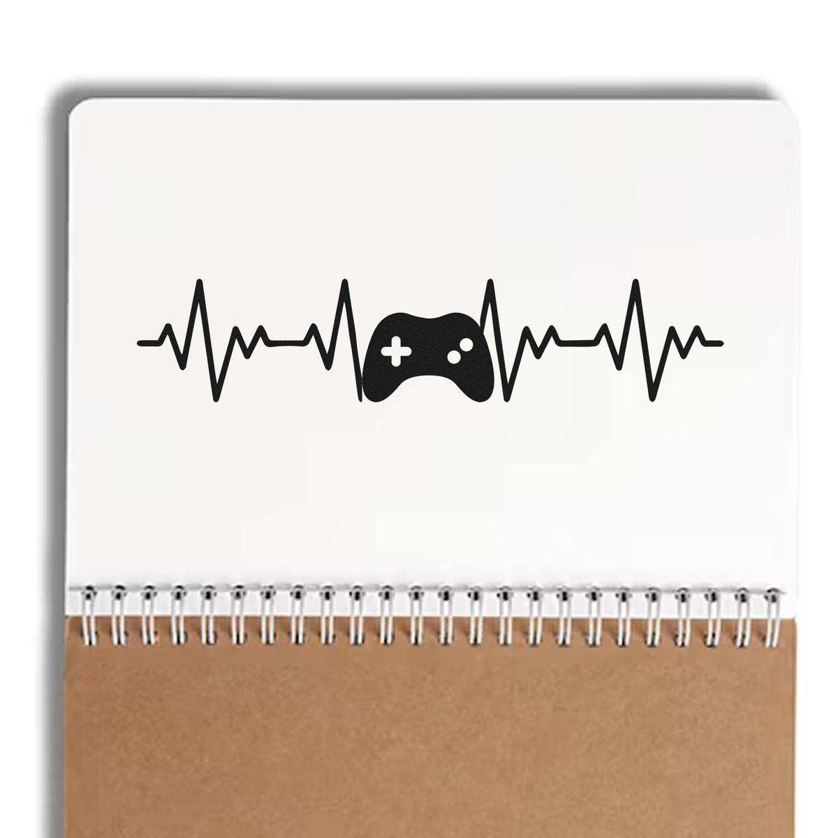 Black heartbeat and game controller stamp seal on white spiral notebook with brown cover
