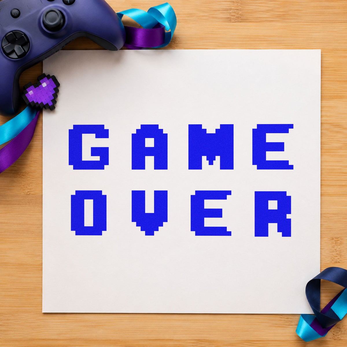 Game Over Pixel Lettering craft stamp in blue ink on cardstock, an easy option for stage drape printing.