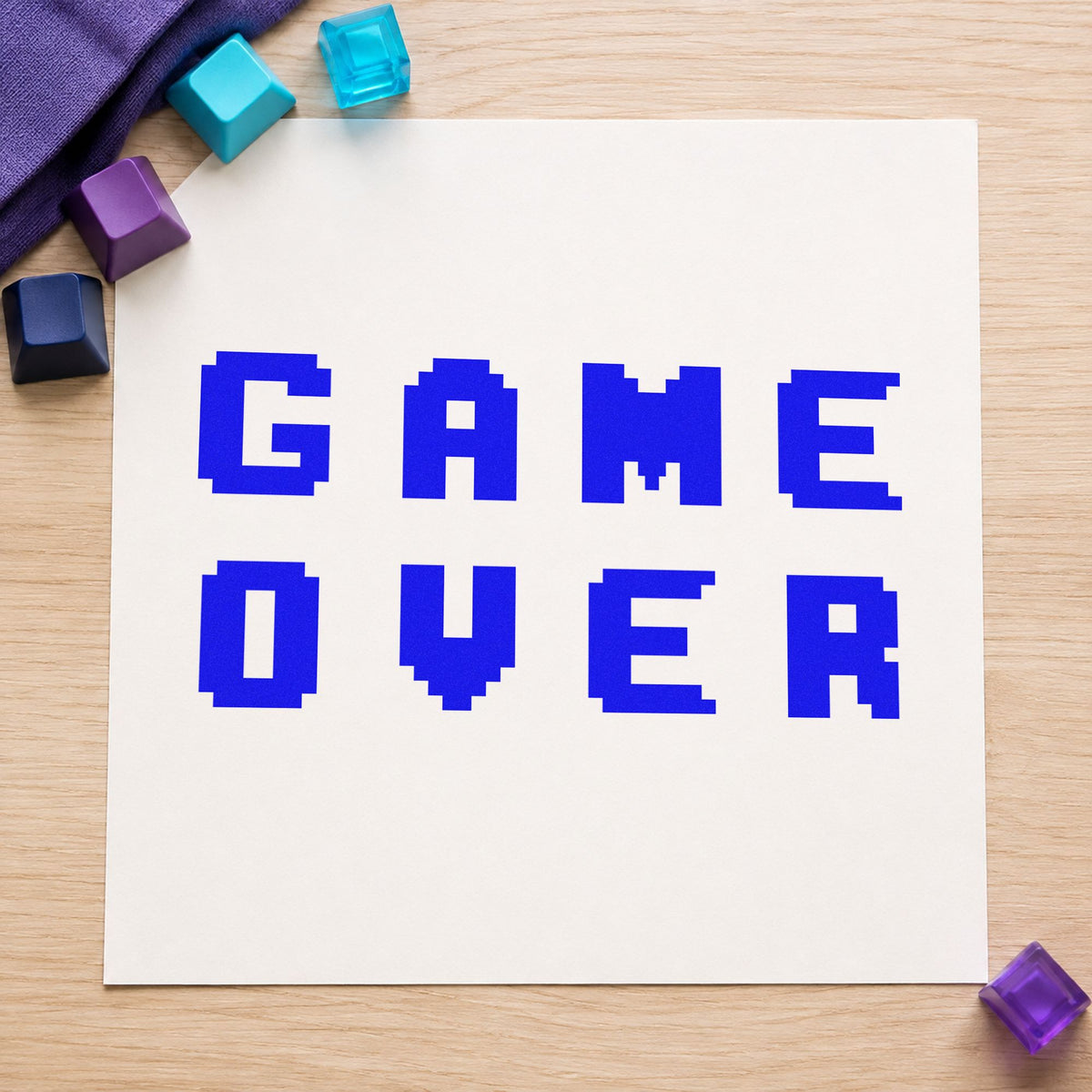 Game Over Pixel Lettering craft stamp imprinted in blue ink on paper, a design suited to framed venue entry.