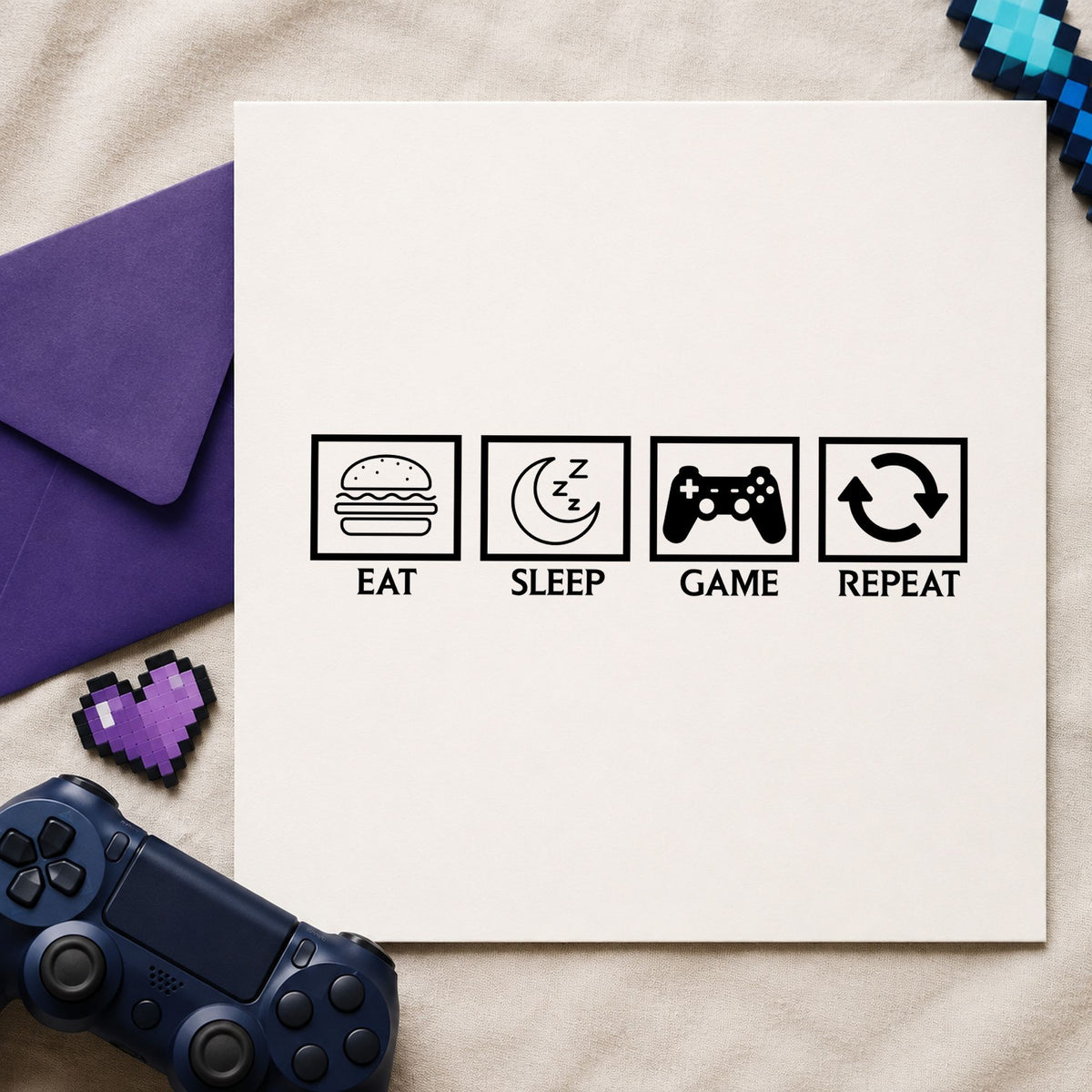 Eat Sleep Game Repeat craft stamp imprint in black ink on a handmade project, one idea being care box gift tags.