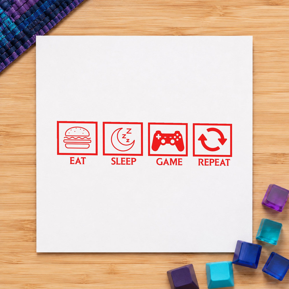 Eat Sleep Game Repeat craft stamp imprint in red ink on a handmade project, one idea being week plan cards.
