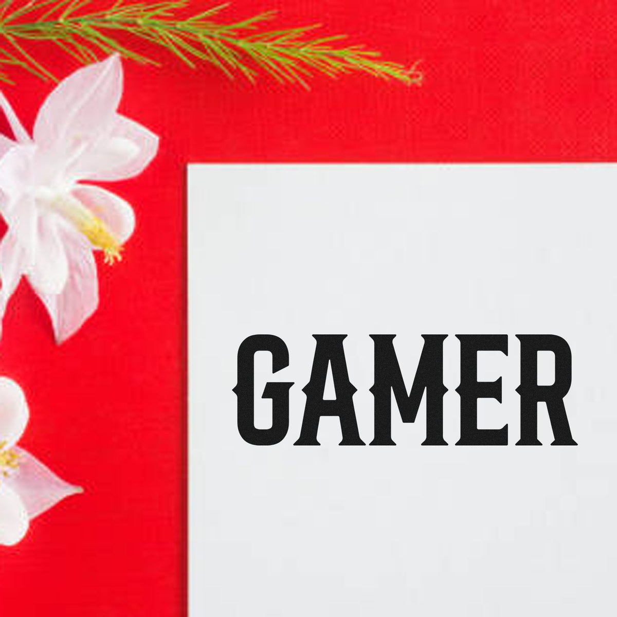 Red stamp and seal design with white flowers and black GAMER text on a white card