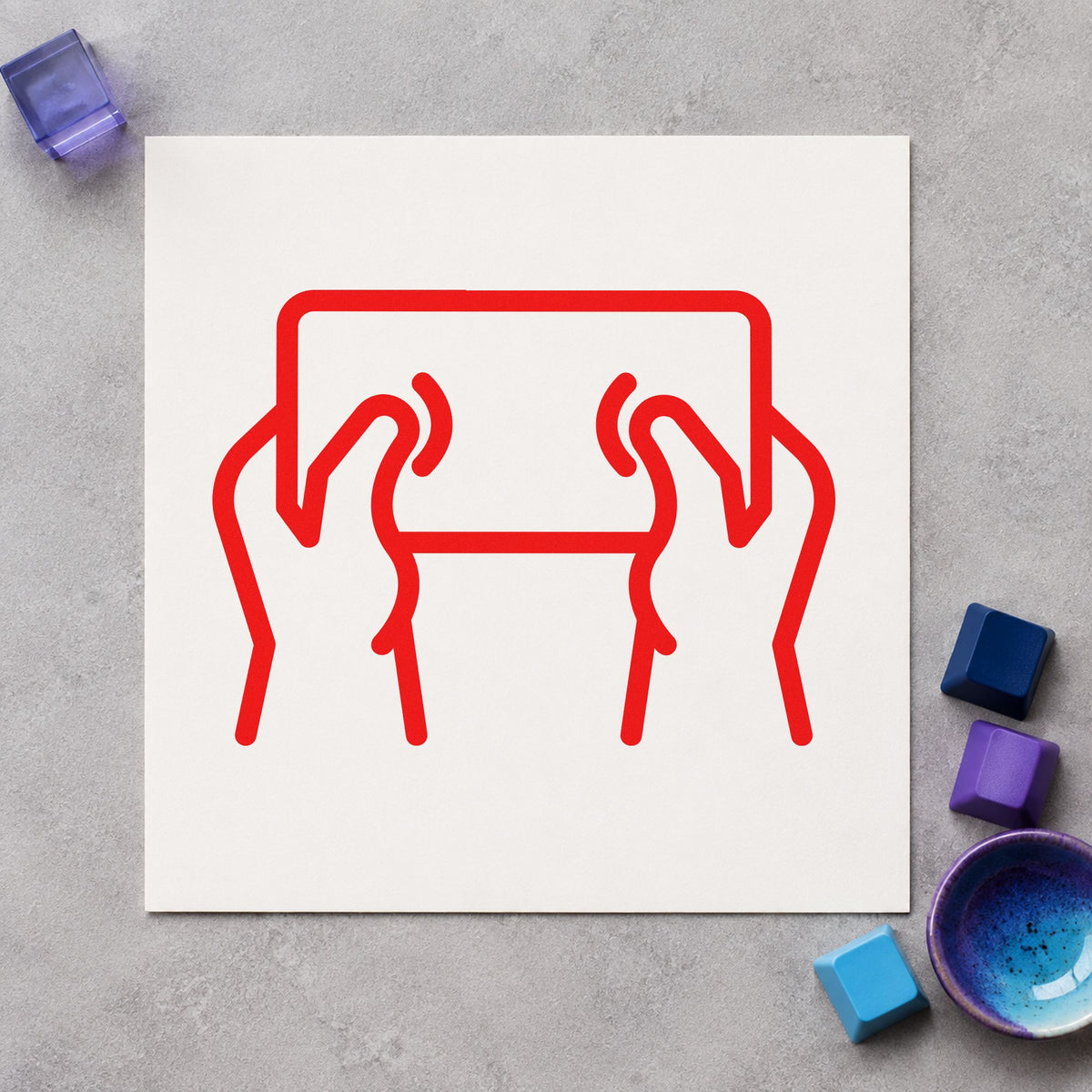 Hands Holding Outlined Tablet craft stamp imprint in red ink on a handmade project, one idea being screen rule cards.
