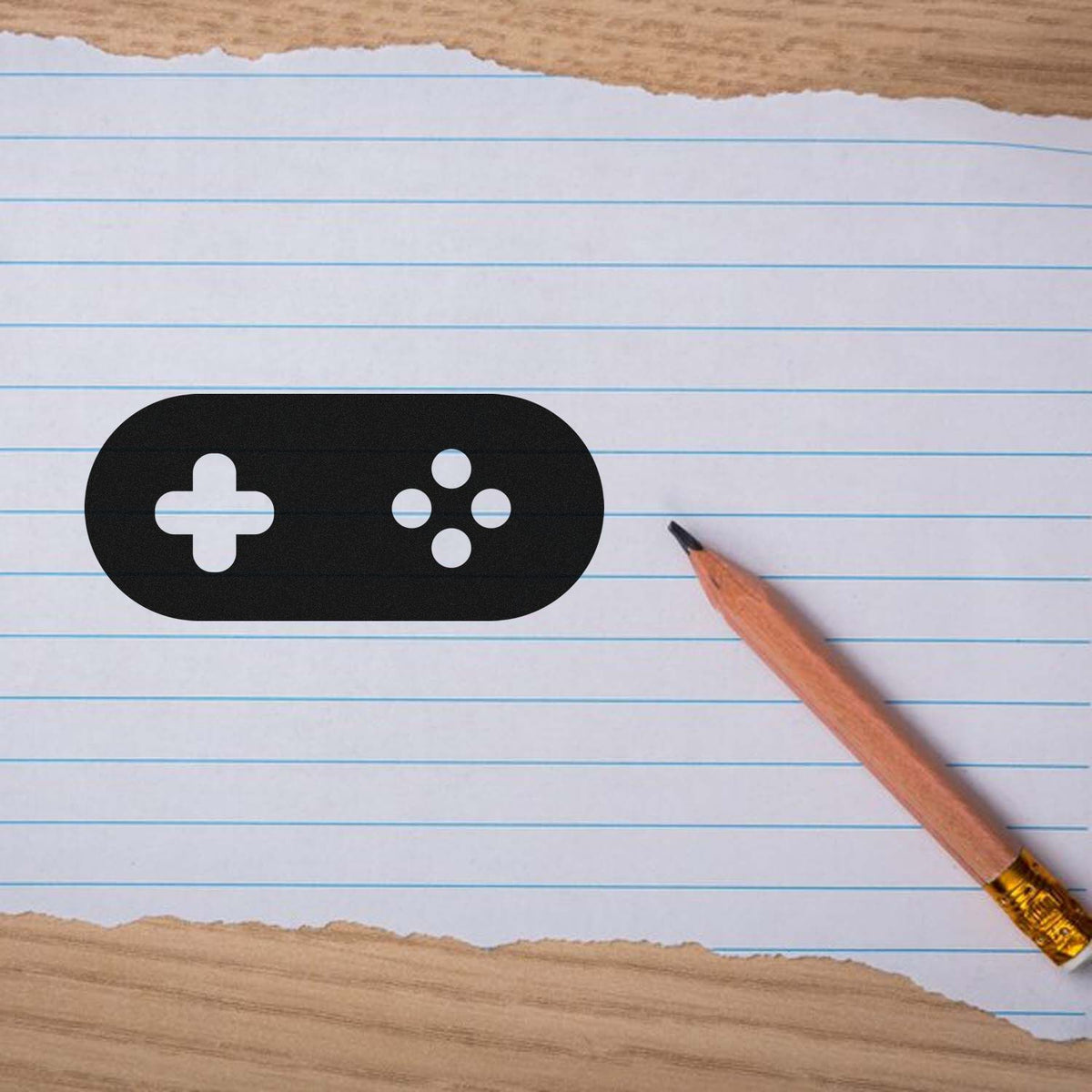 Black stamp and seal product with white plus and dot icons on lined paper beside a wooden pencil.