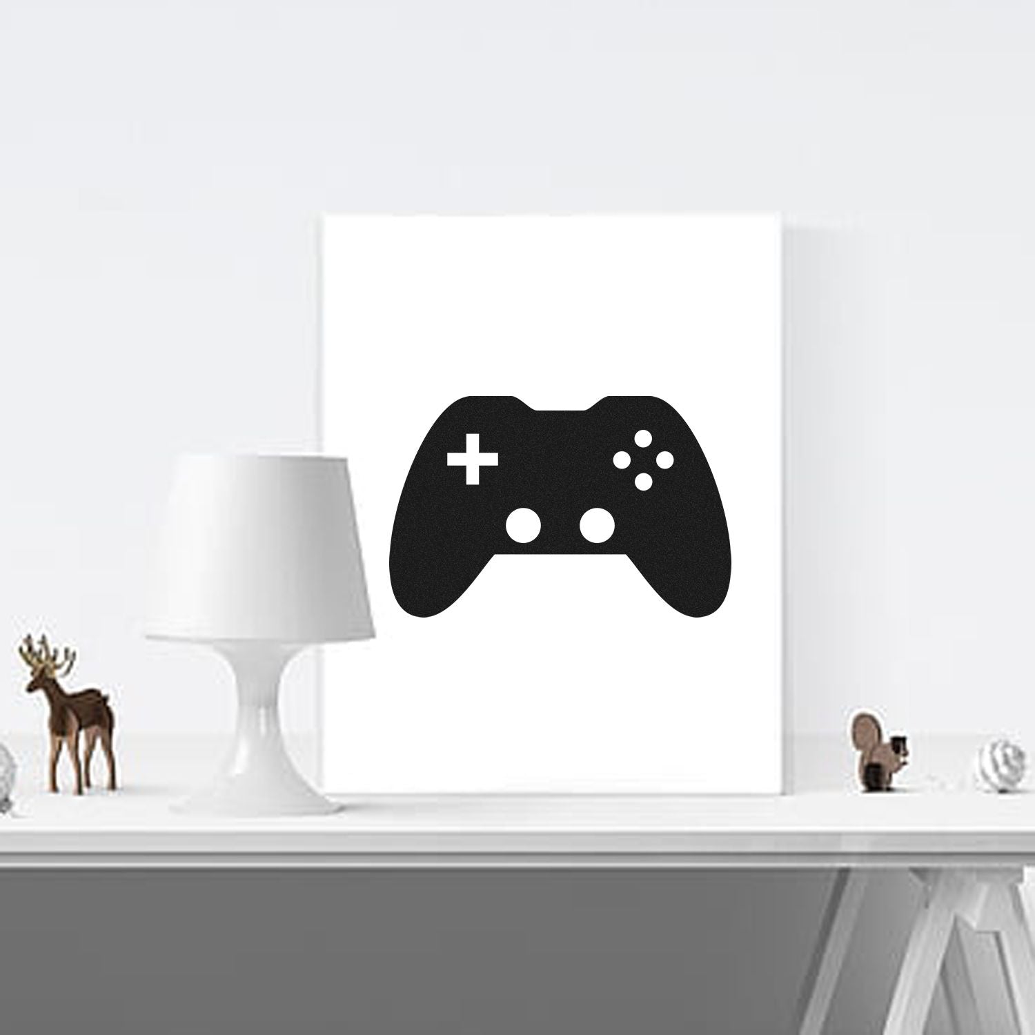 Black game controller stamp and seal with white button icons on a white display board.