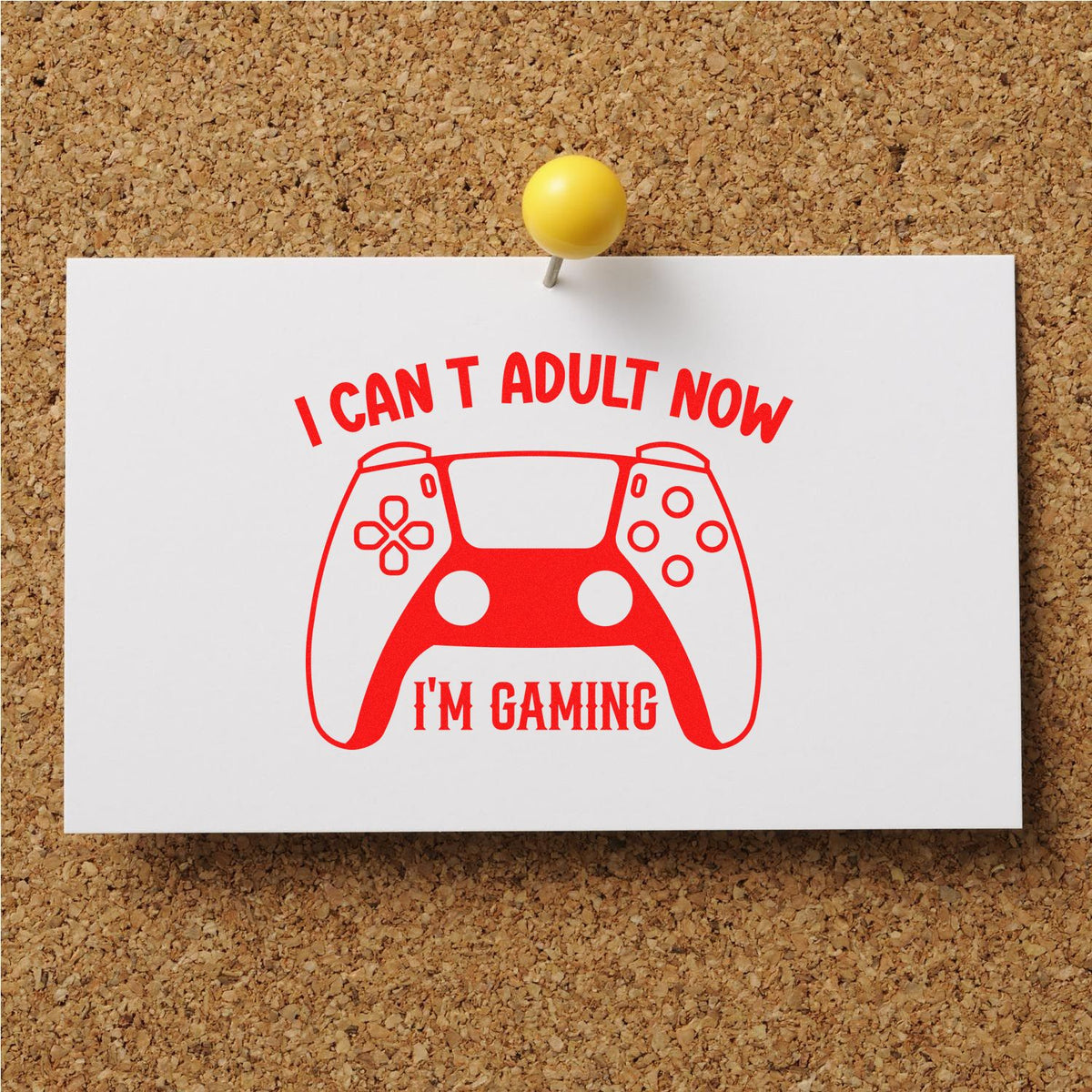 Red rubber stamp-style gaming controller with I cant adult now, Im gaming on a white card, pinned to corkboard.