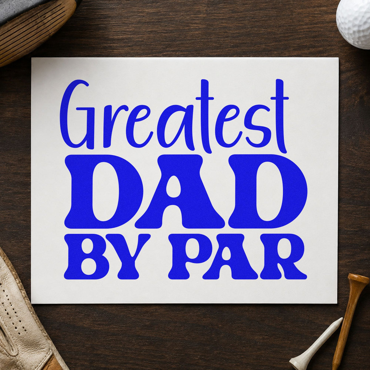 Greatest Dad By Par craft stamp imprinted in blue ink on paper, a design suited to framed study corner.
