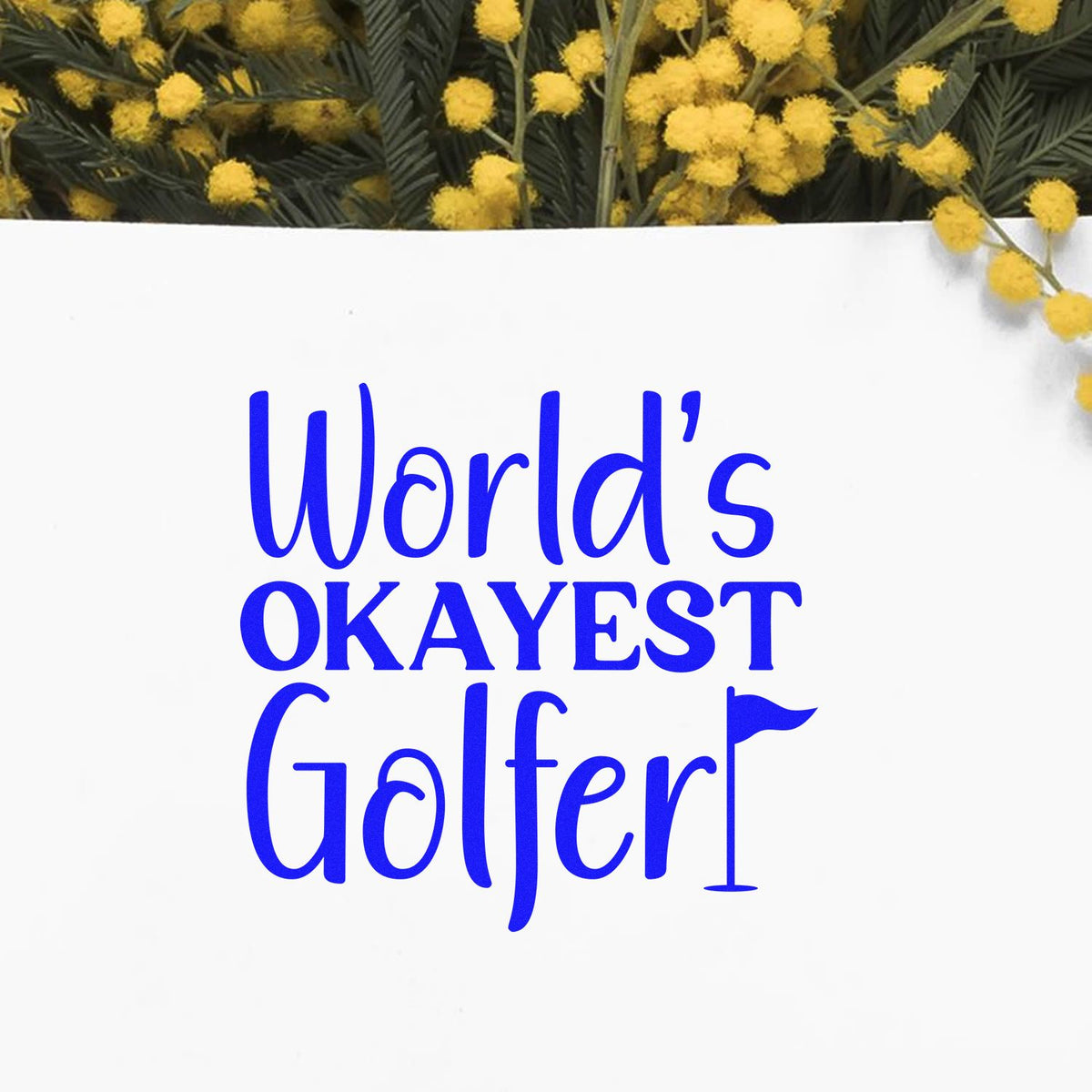 Blue World's OKAYEST Golfer stamp/seal on white, framed by yellow flowers