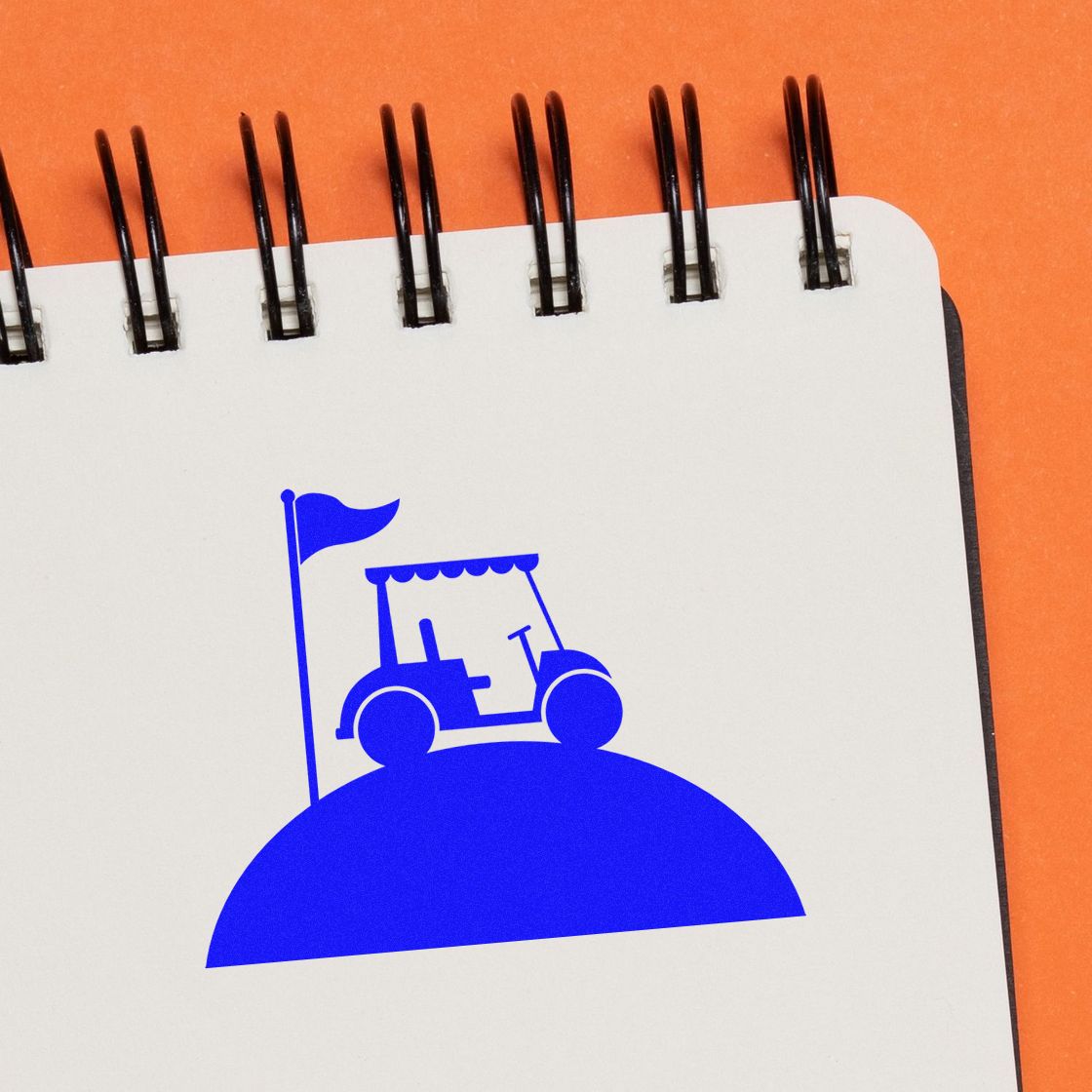 Blue stamp seal featuring a golf cart on a spiral notepad, set against an orange background.
