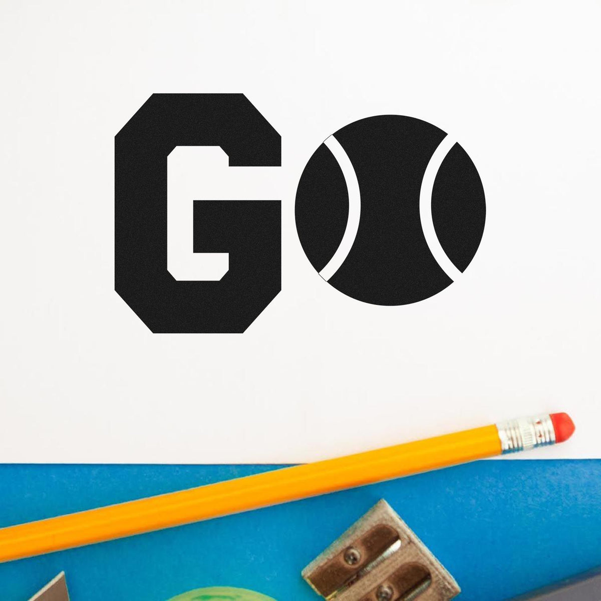 Black GO stamp and seal products on white paper, with a yellow pencil over a blue background.