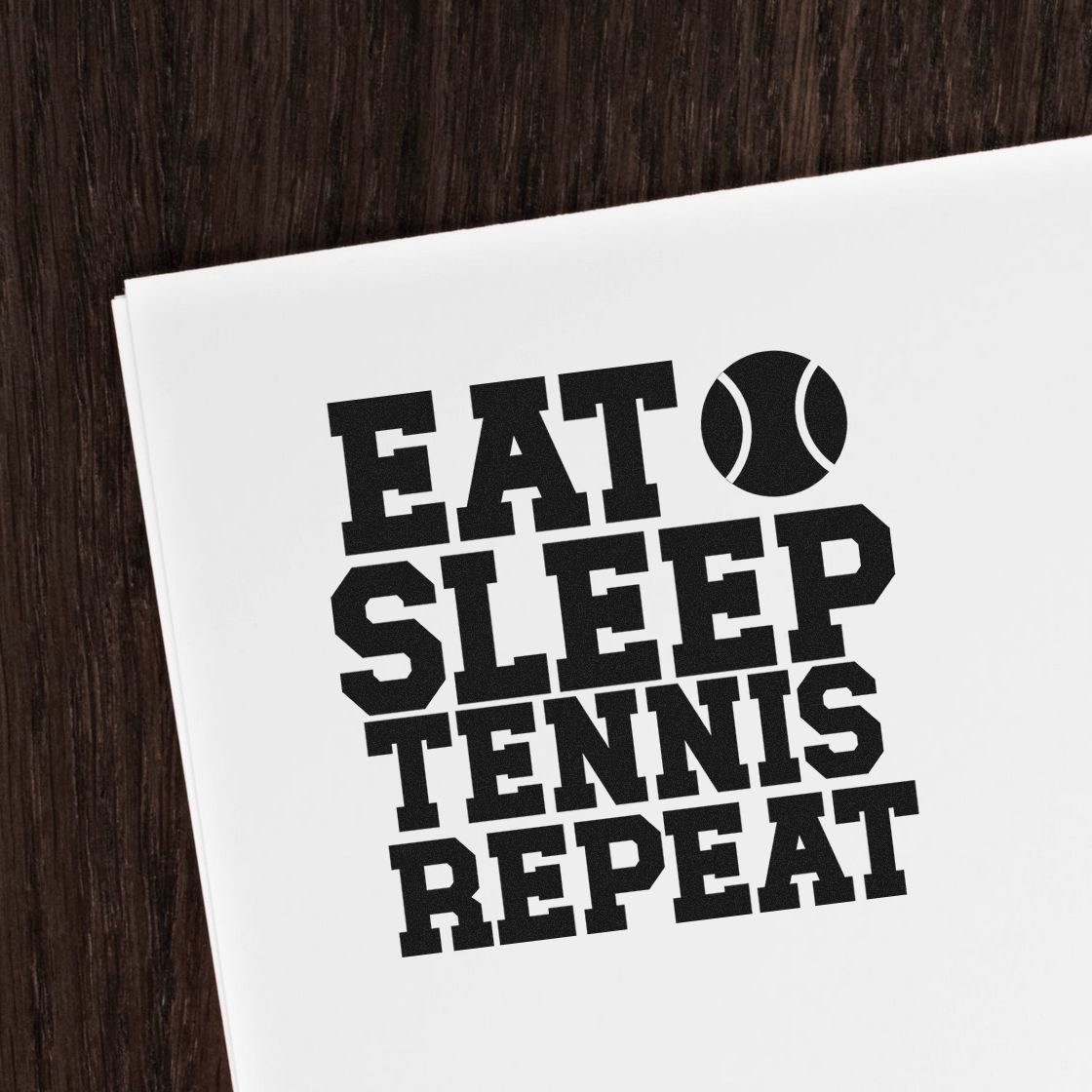 Black tennis stamp and seal design on white paper, with tennis ball icon and bold EAT SLEEP TENNIS REPEAT text.