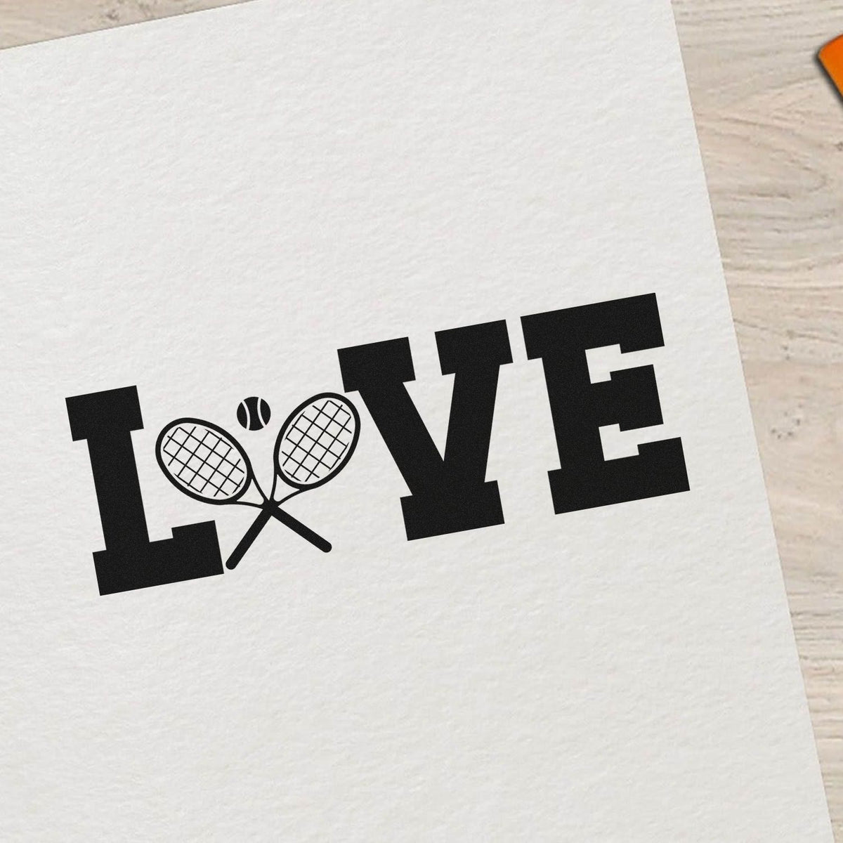 Black LOVE tennis stamp and seal design on white paper, with crossed rackets replacing the O and a tennis ball.