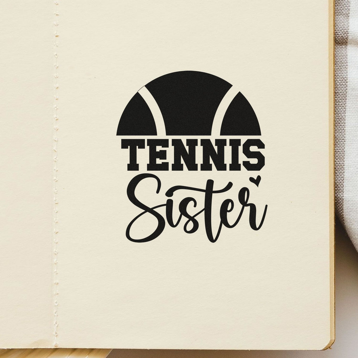 Black tennis sister stamp seal on cream paper, featuring bold black text, tennis ball graphic and small heart.