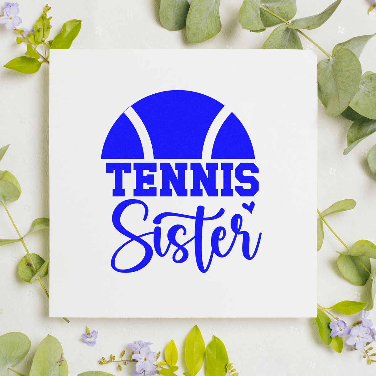 Blue Tennis Sister stamp seal with tennis ball graphic on a white square card, surrounded by green leaves and purple flowers.