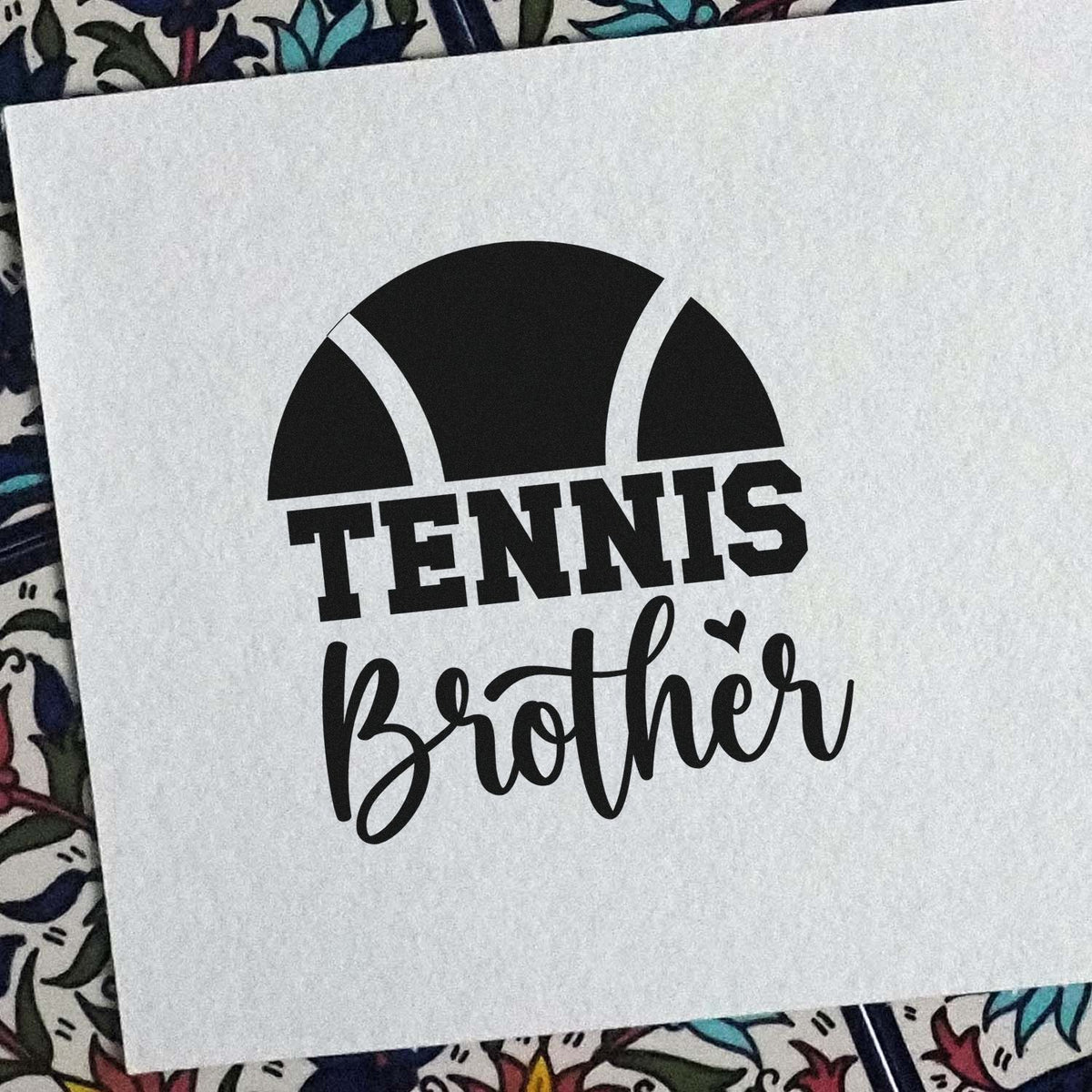 Black custom stamp seal design with tennis ball graphic and Tennis Brother lettering on white paper.