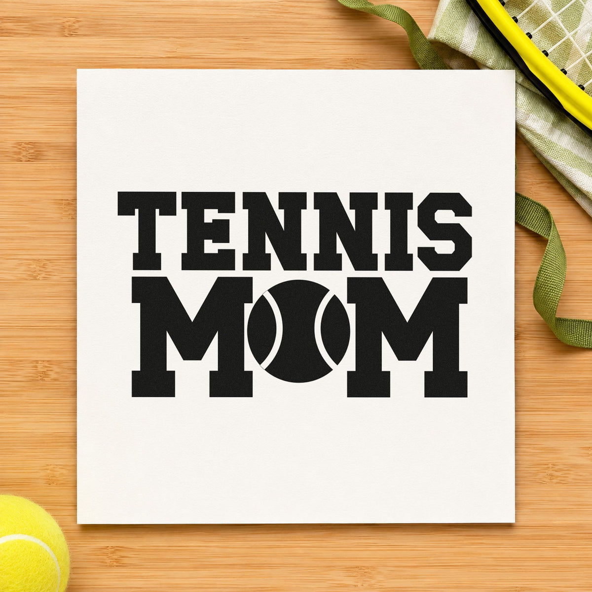 Tennis Mom Ball Letter craft stamp imprint in black ink on a handmade project, one idea being driver gift tags.
