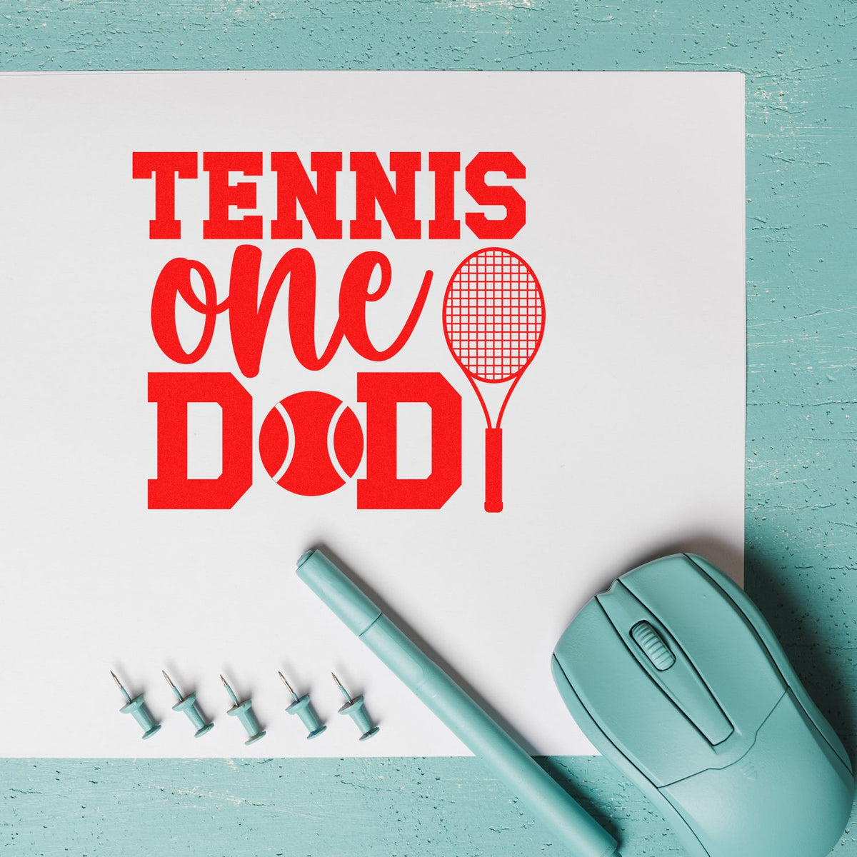 Red tennis-themed one DAD stamp design on white card, with racket and ball, teal stamp seal, pen, and pins.