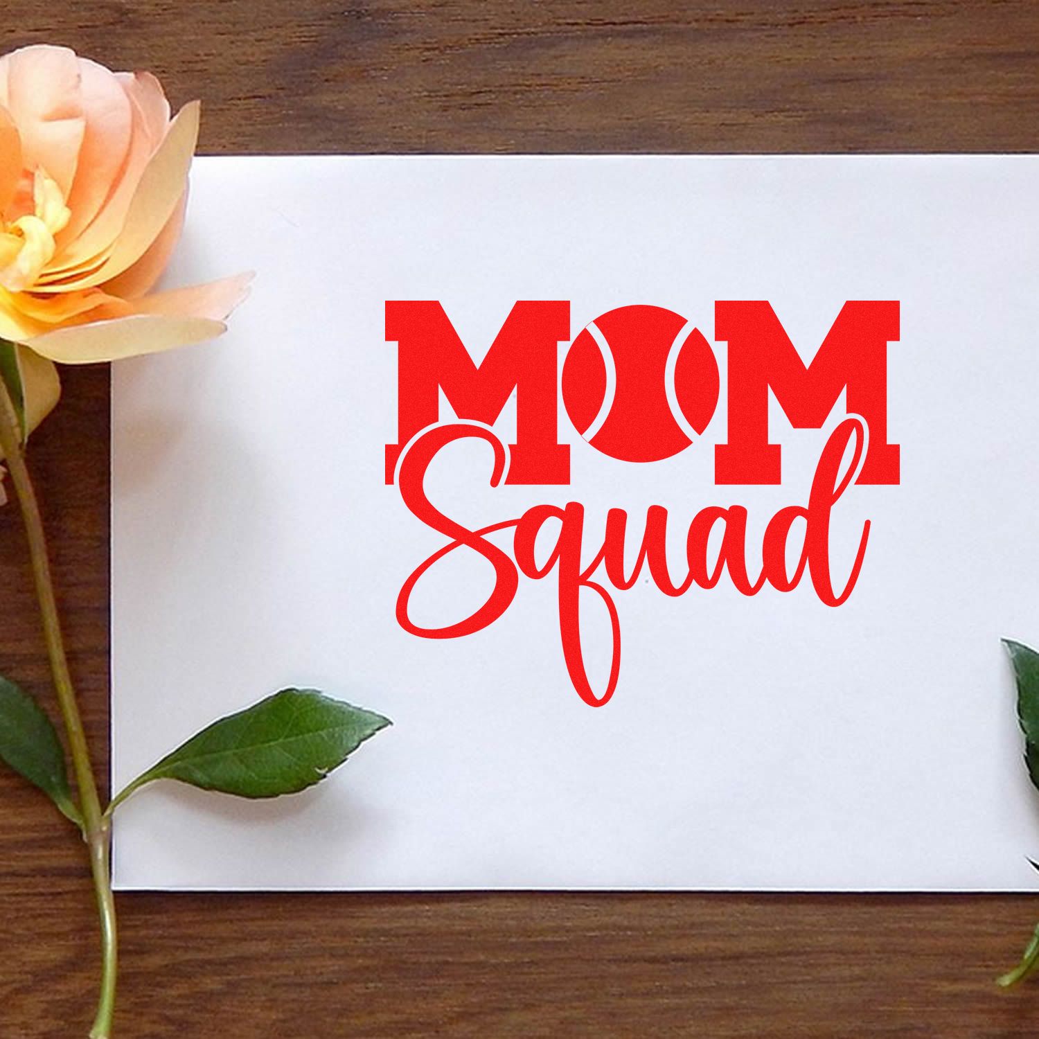 Red MOM Squad custom stamp and seal design on white card, with peach rose, green leaves, and wood background.