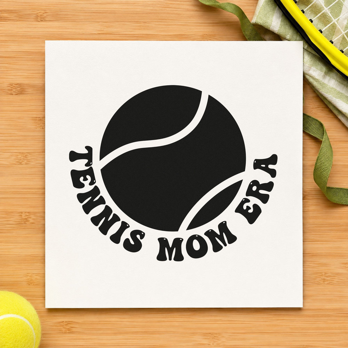 Tennis Mom Era Ball craft stamp imprint in black ink on a handmade project, one idea being road snack gift tags.