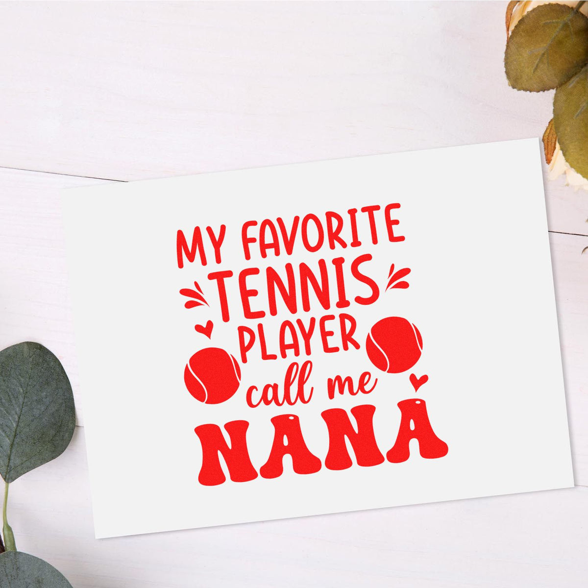Red tennis-themed stamp design reading My favorite tennis player call me Nana with tennis balls on a white background.