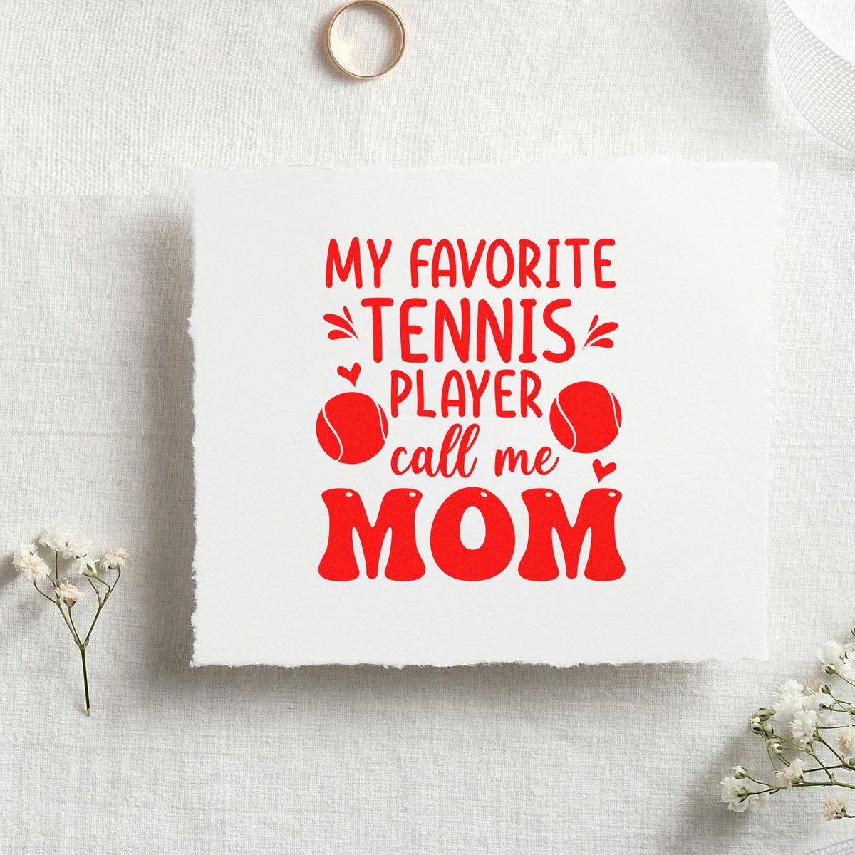 Red tennis-themed stamp/seal design on white paper reading My favorite tennis player call me Mom with tennis balls.