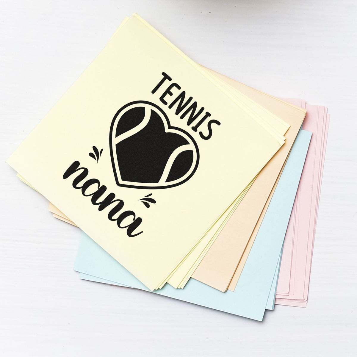 Pastel stamp and seal sheets in cream, blue, pink and beige with black tennis heart design and Tennis Nana text