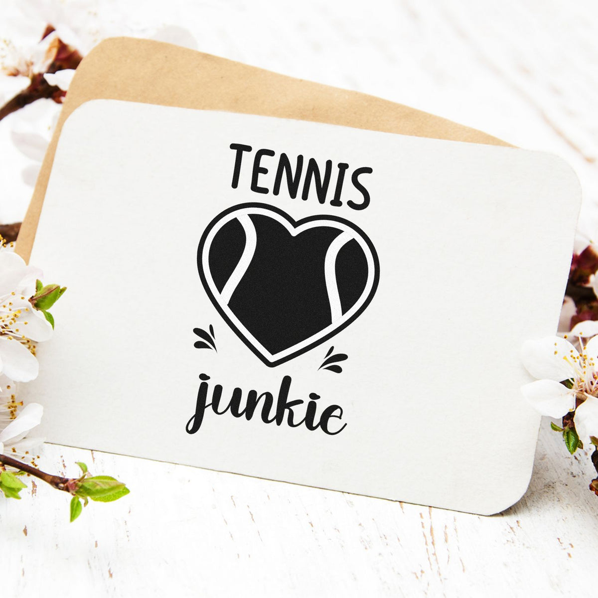 Custom black tennis heart stamp and seal on white card with tan backing and floral accents