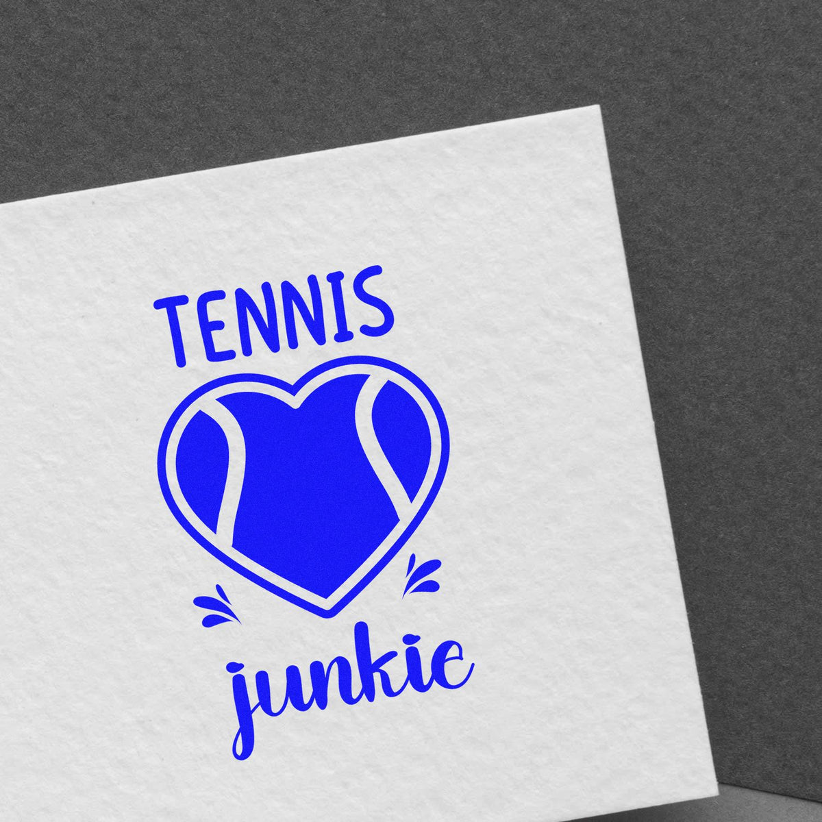 Blue tennis junkie stamp and seal on white paper with a heart-shaped tennis ball design
