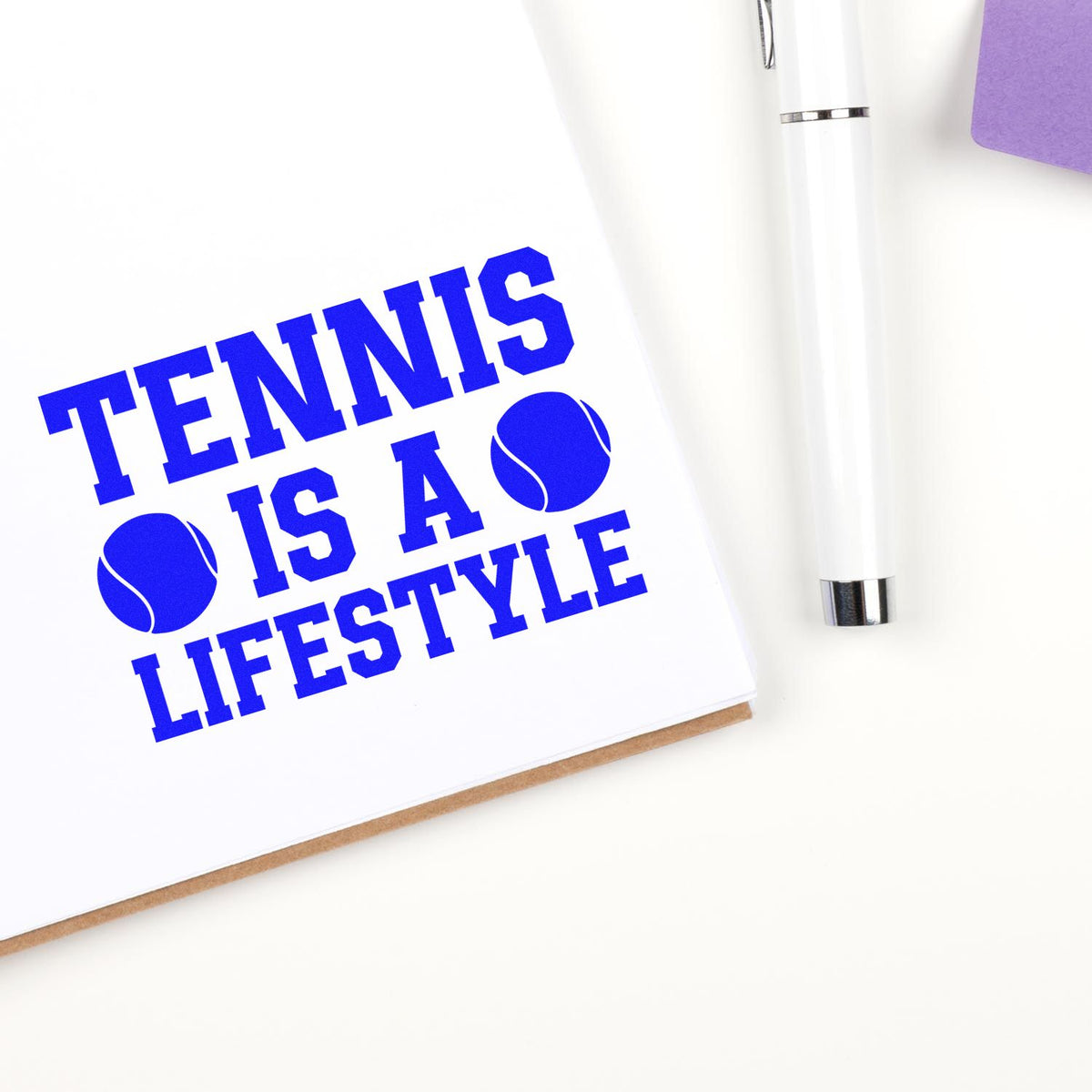 Blue tennis-themed custom stamp and seal reading TENNIS IS A LIFESTYLE, with tennis balls, white pen, and purple accent.