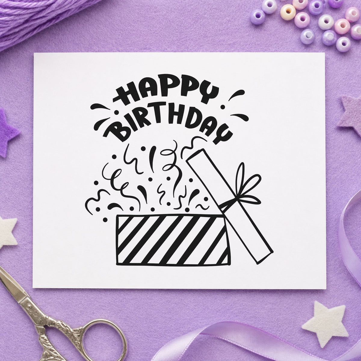 Birthday Open Gift Confetti craft stamp imprint in black ink on a handmade project, one idea being parcel ribbon tags.