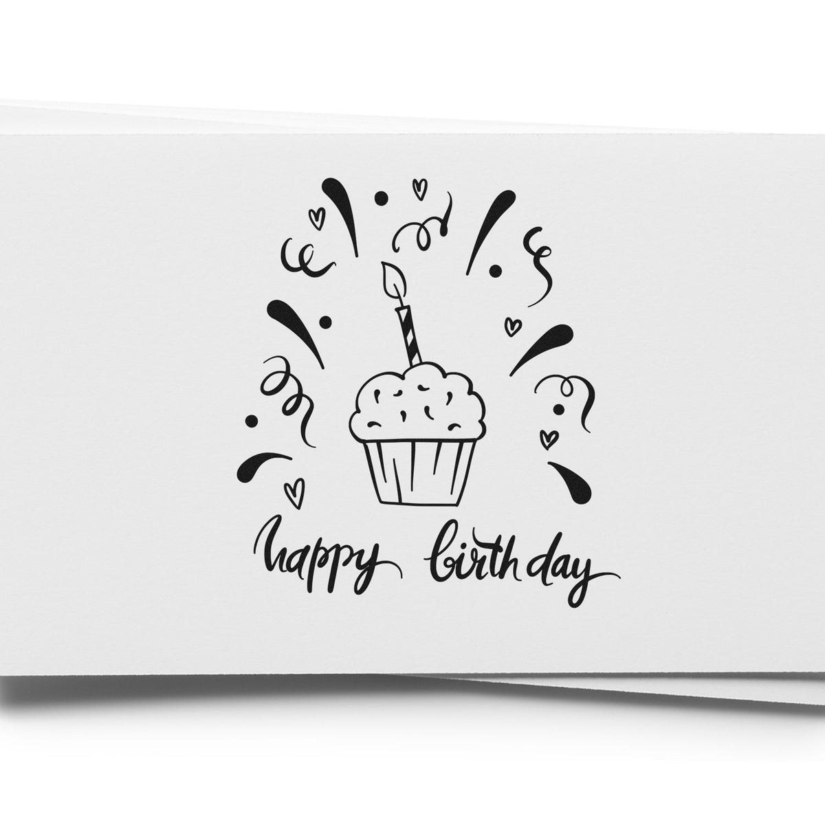 Black happy birthday stamp and seal with cupcake, hearts, and confetti on white paper.