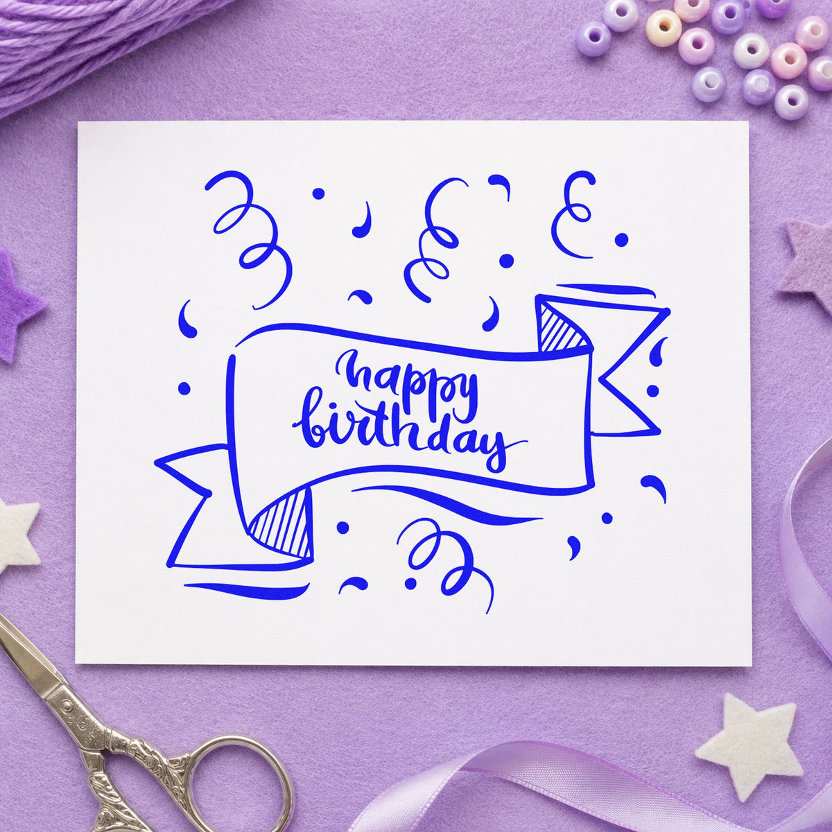 Happy Birthday Ribbon Banner craft stamp in blue ink on cardstock, an easy option for packing cloth printing.