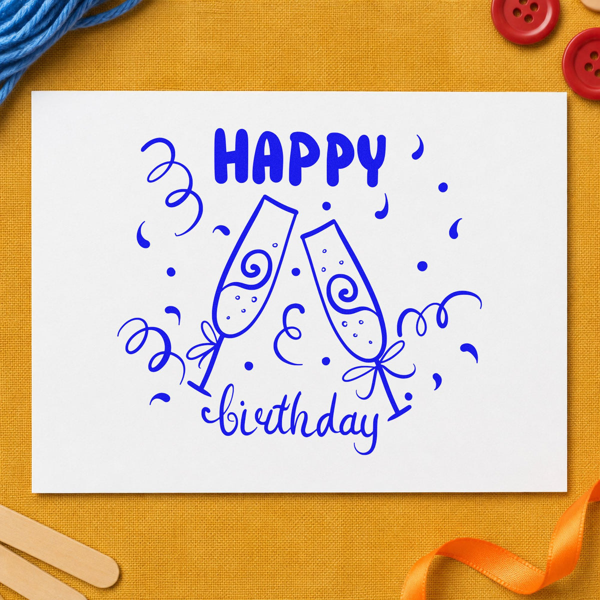 Birthday Toast Champagne Flutes craft stamp in blue ink on cardstock, an easy option for bar towel printing.