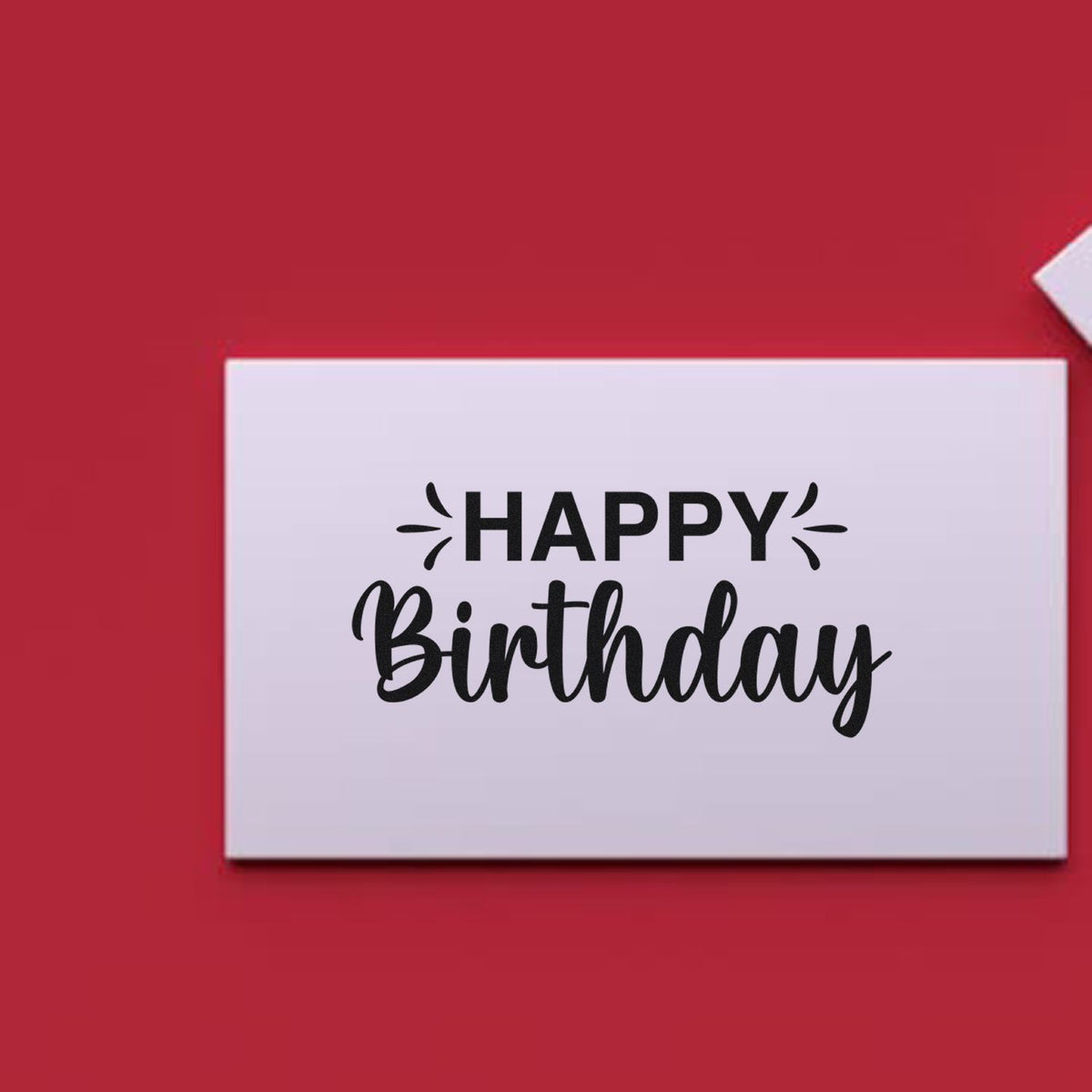 White rectangular Happy Birthday stamp seal with black lettering on a red background.
