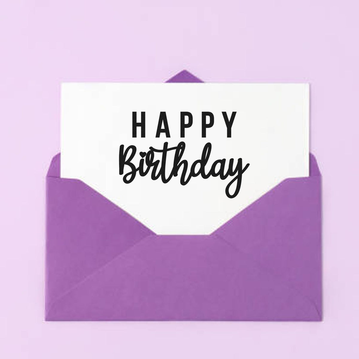 Purple envelope with white Happy Birthday card, stamp and seal product on a lavender background.