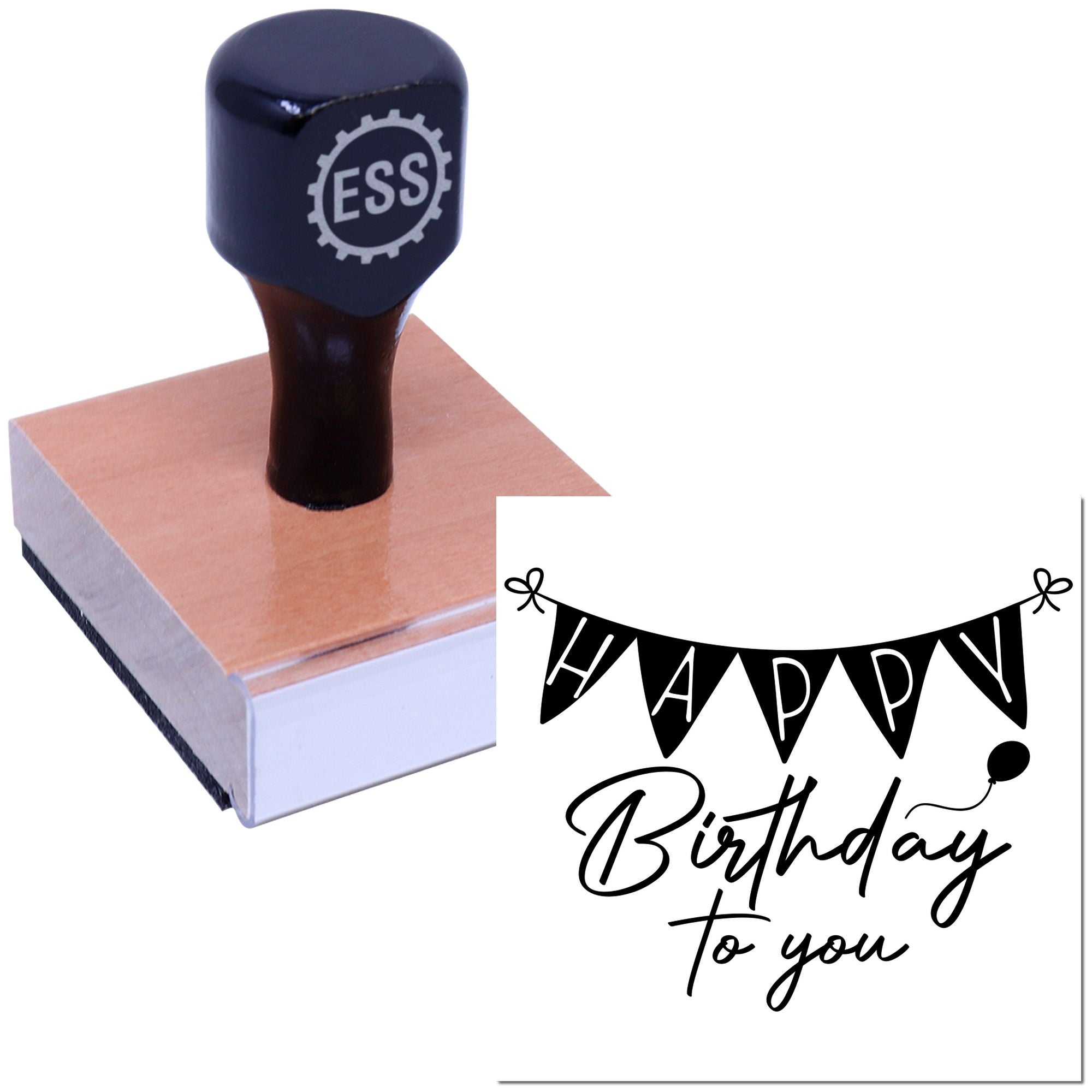 Dark blue ESS rubber stamp on a brown wooden block with black-and-white Happy Birthday to you seal design