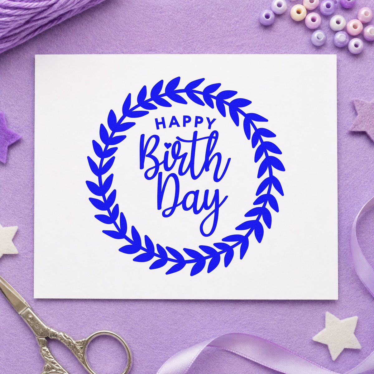 Happy Birthday Leafy Wreath craft stamp in blue ink on cardstock, an easy option for picnic blanket printing.