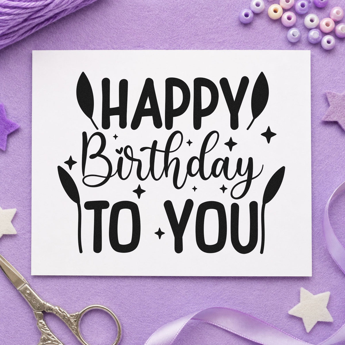 Happy Birthday To You craft stamp imprint in black ink on a handmade project, one idea being posted gift tags.