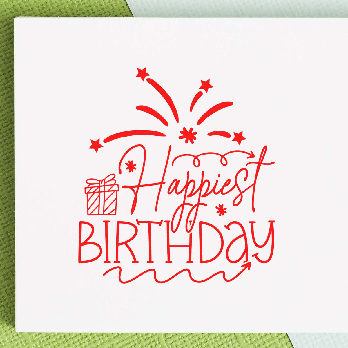 Red birthday stamp seal reading Happiest Birthday with fireworks and gift icon on white paper.