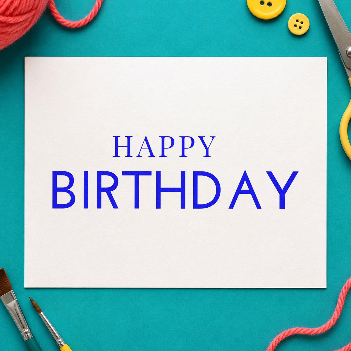 Simple Happy Birthday Capitals craft stamp in blue ink on cardstock, an easy option for linen napkin printing.