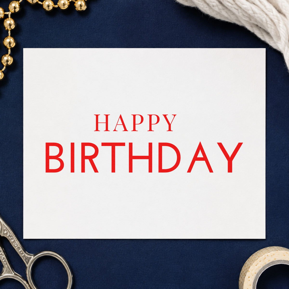 Simple Happy Birthday Capitals craft stamp imprint in red ink on a handmade project, one idea being place card notes.