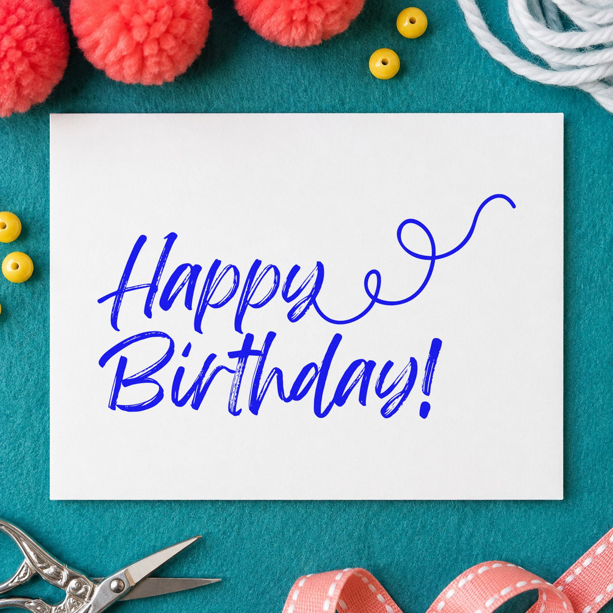 Happy Birthday Curl Flourish craft stamp in blue ink on cardstock, an easy option for notebook sleeve printing.