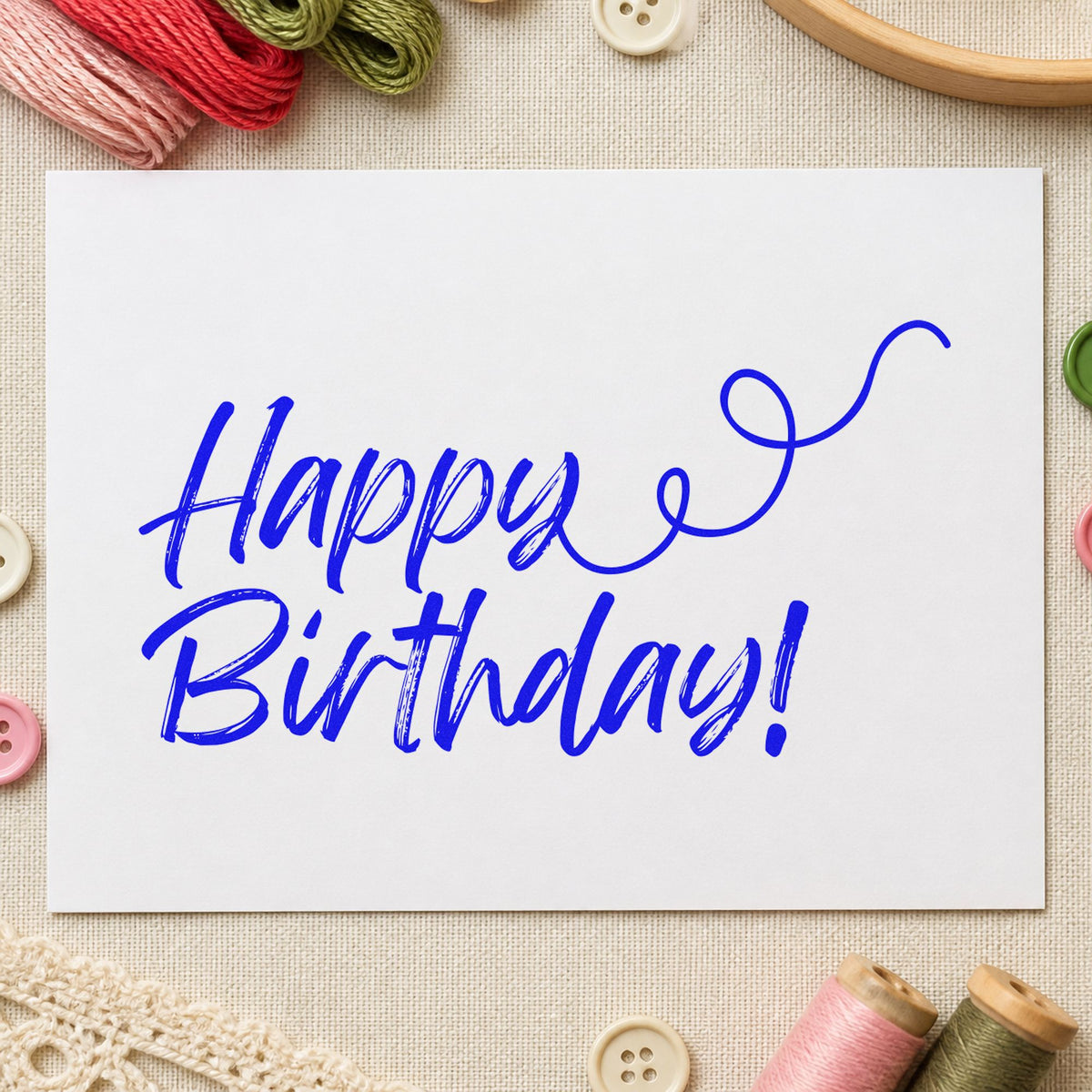 Happy Birthday Curl Flourish craft stamp imprinted in blue ink on paper, a design suited to framed writing desk.