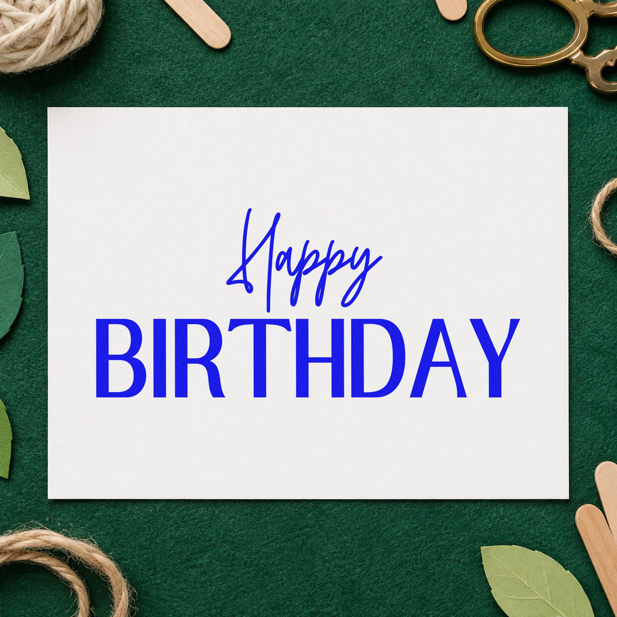 Happy Birthday Narrow Capitals craft stamp imprinted in blue ink on paper, a design suited to framed front desk.
