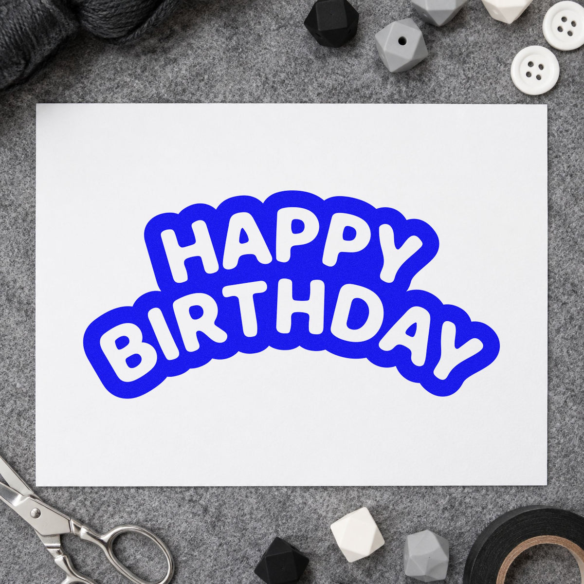 Happy Birthday Bubble Outline craft stamp in blue ink on cardstock, an easy option for staff tee printing.