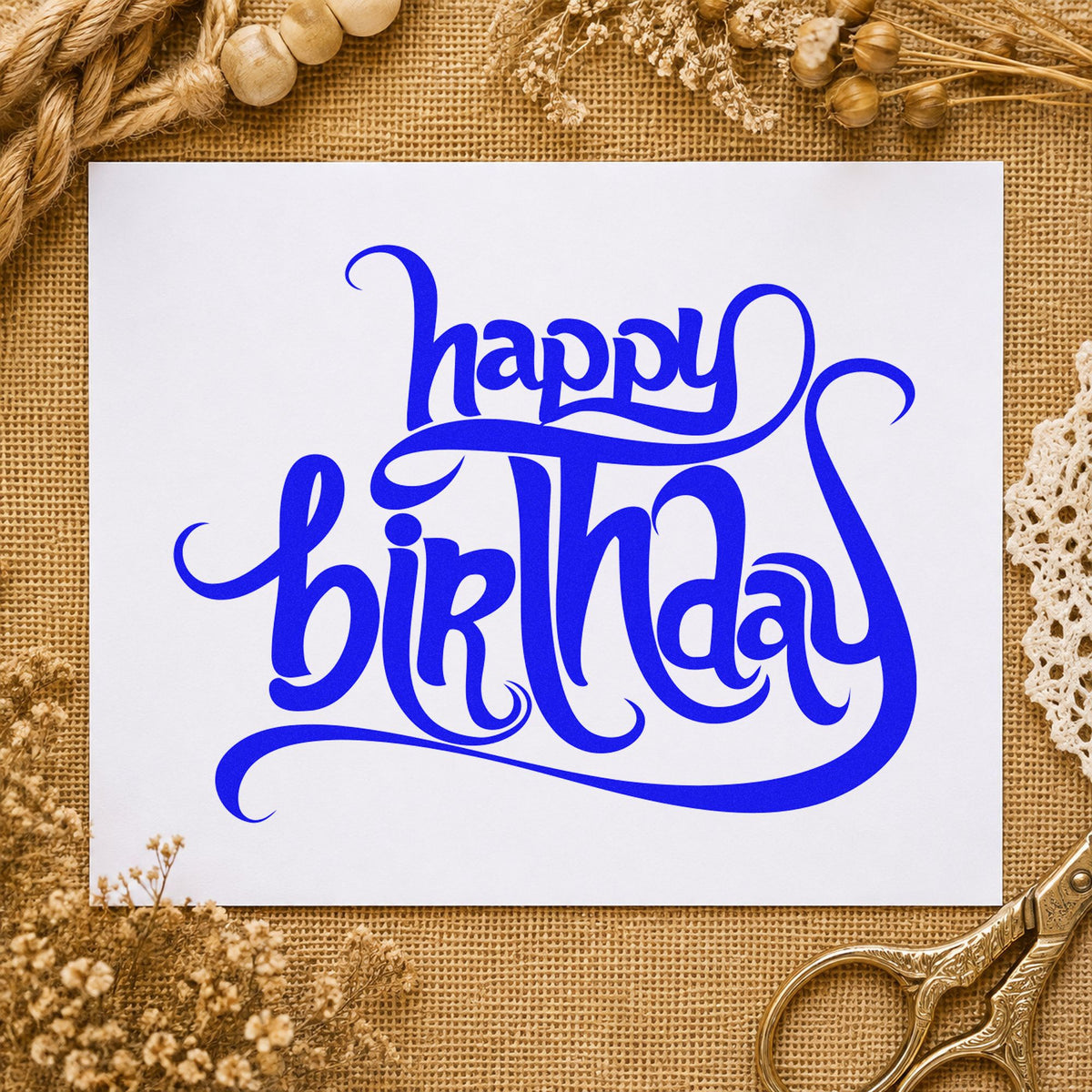 Ornate Happy Birthday Flourishes craft stamp in blue ink on cardstock, an easy option for lace cloth printing.