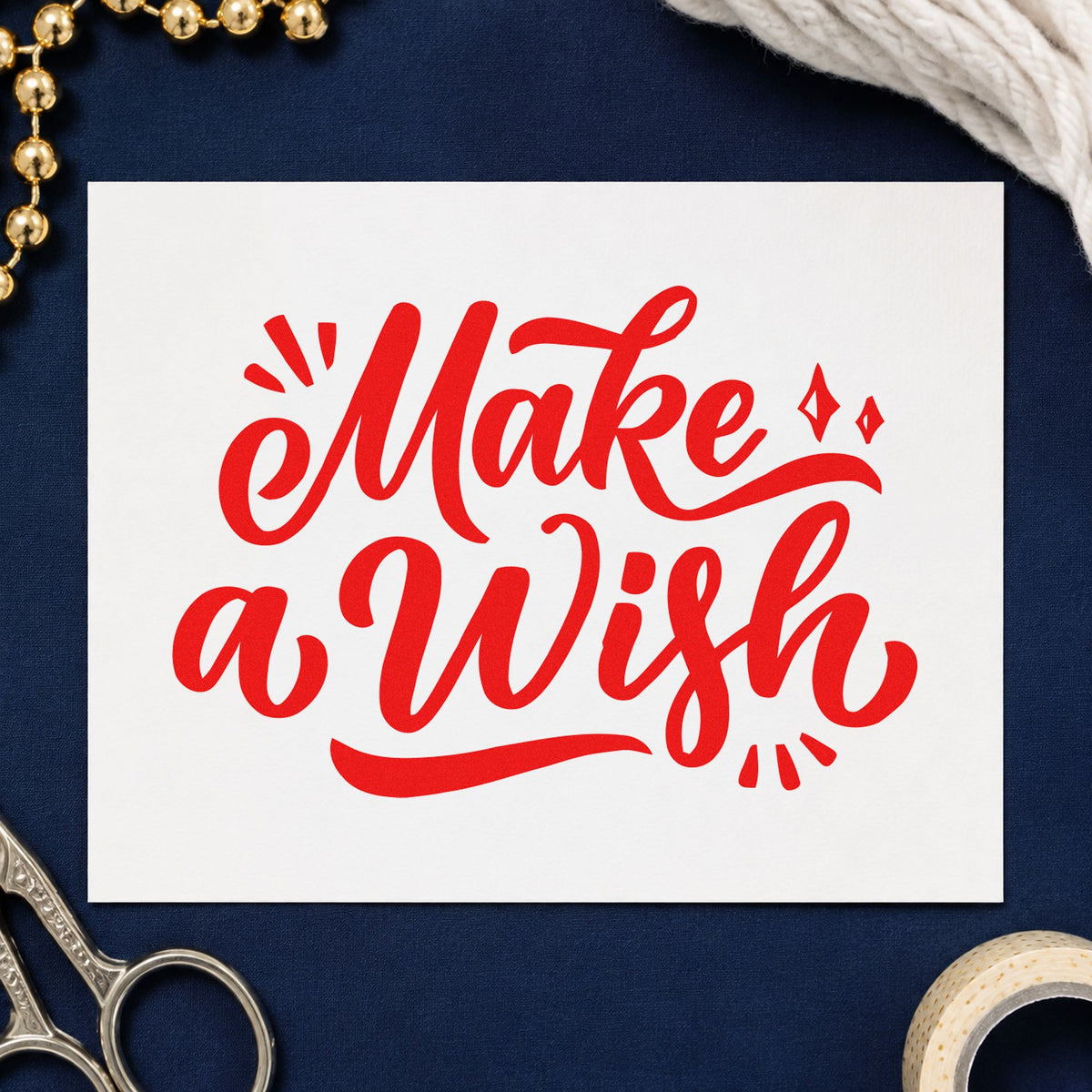 Make A Wish Script craft stamp imprint in red ink on a handmade project, one idea being wish slip cards.