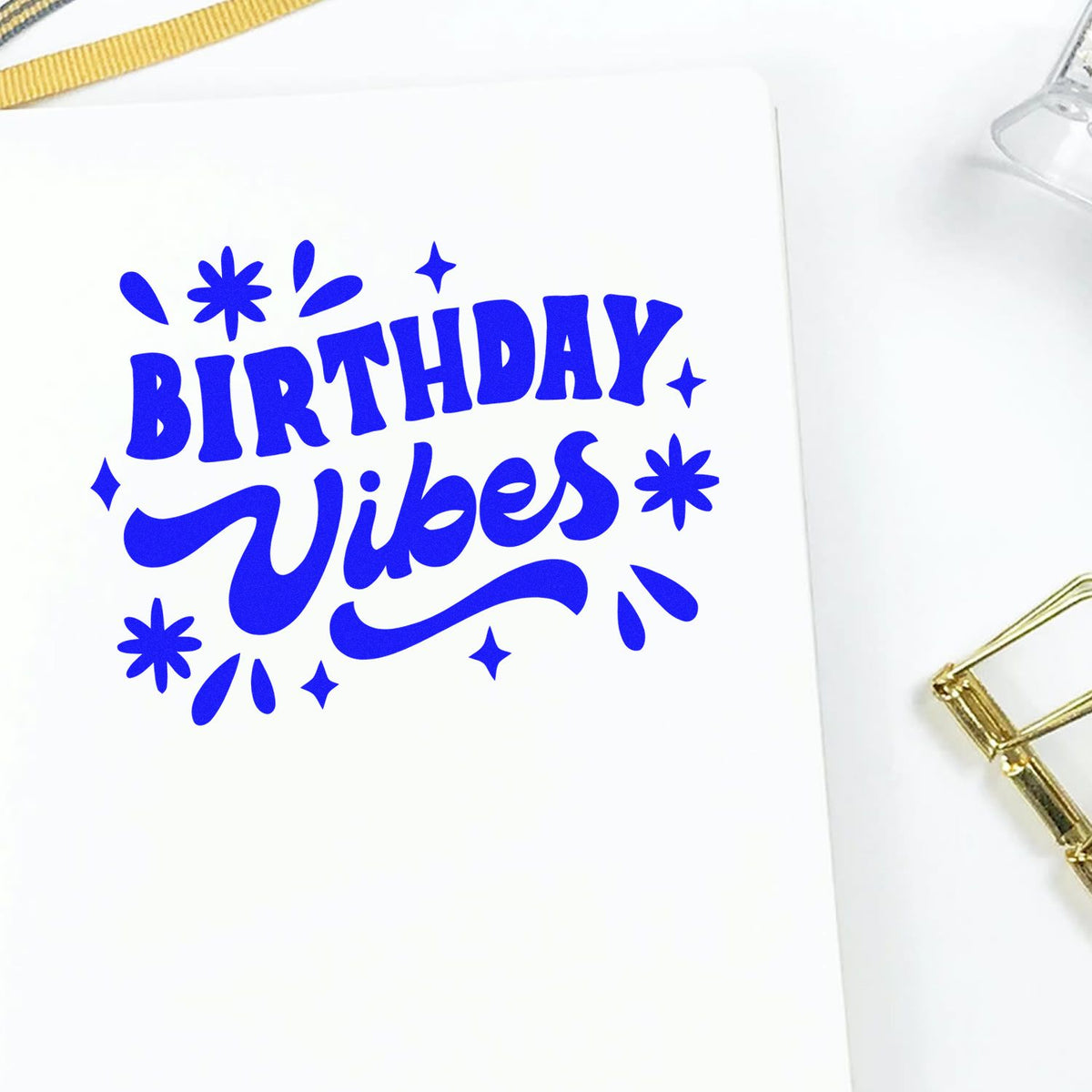 Blue Birthday Vibes stamp and seal design in vivid blue on white paper, with playful sparkles and gold accents.