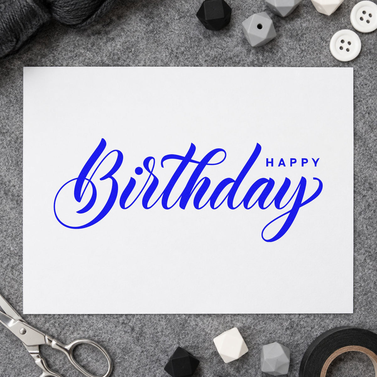 Birthday Script Small Happy craft stamp in blue ink on cardstock, an easy option for hoop cloth printing.