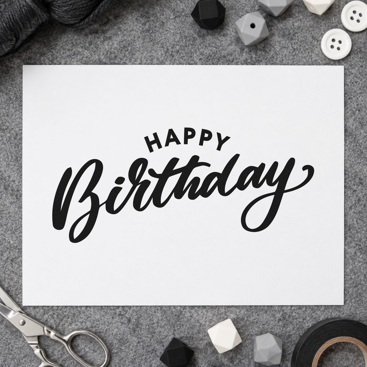 Happy Birthday Arched Heading craft stamp imprint in black ink on a handmade project, one idea being display box gift tags.